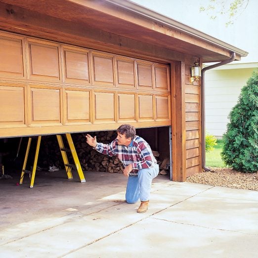 A Man In front of Garage, How To Give Your Garage Door A Tune Up Fh01feb 02102011 Ksedit Ft