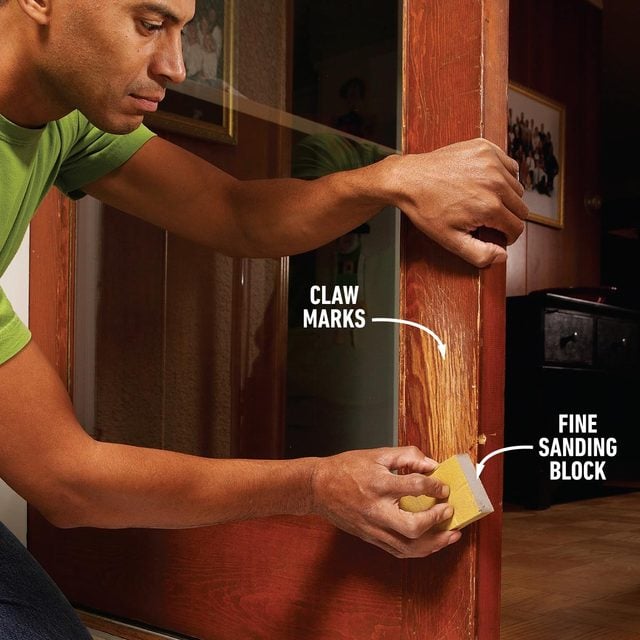 Lighting sanding the claw mark area to fix pet scratches on wood door