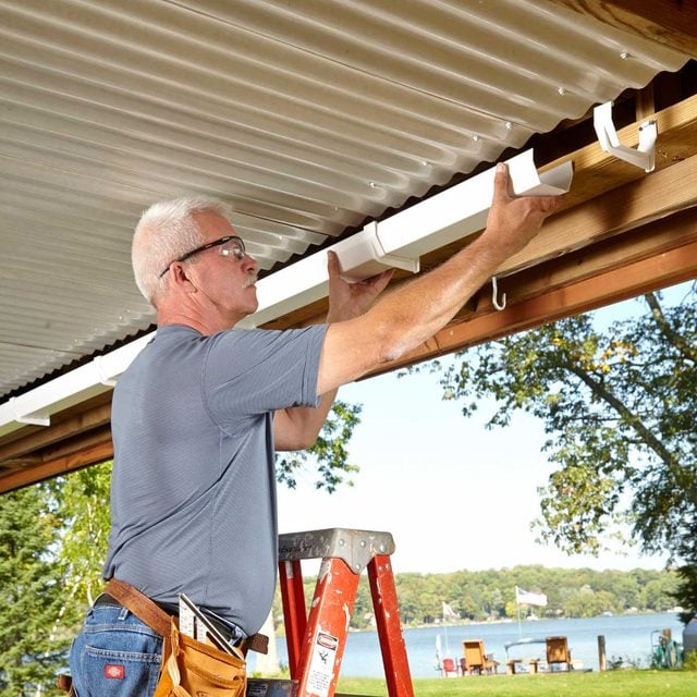 under deck roof install gutters and downspouts