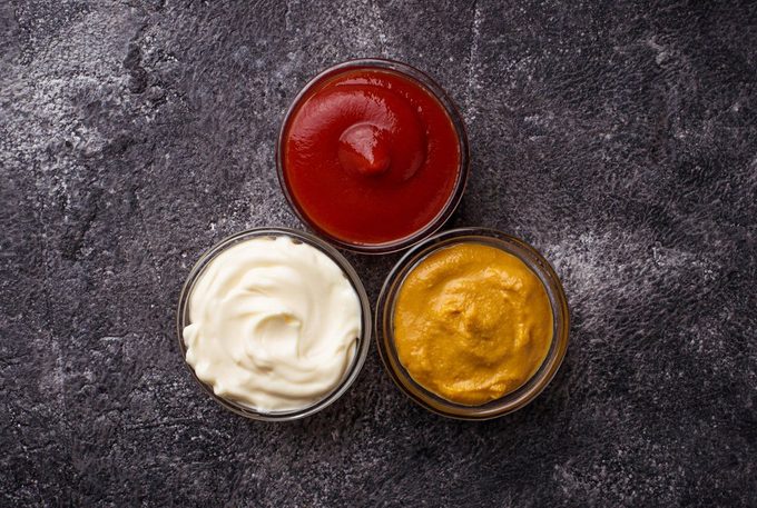 Set of different sauces: mustard, ketchup, mayonnaise. Top view