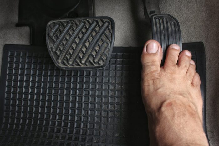 Close up driver's bare foot on pedal in car ,Safety to driving concept.
