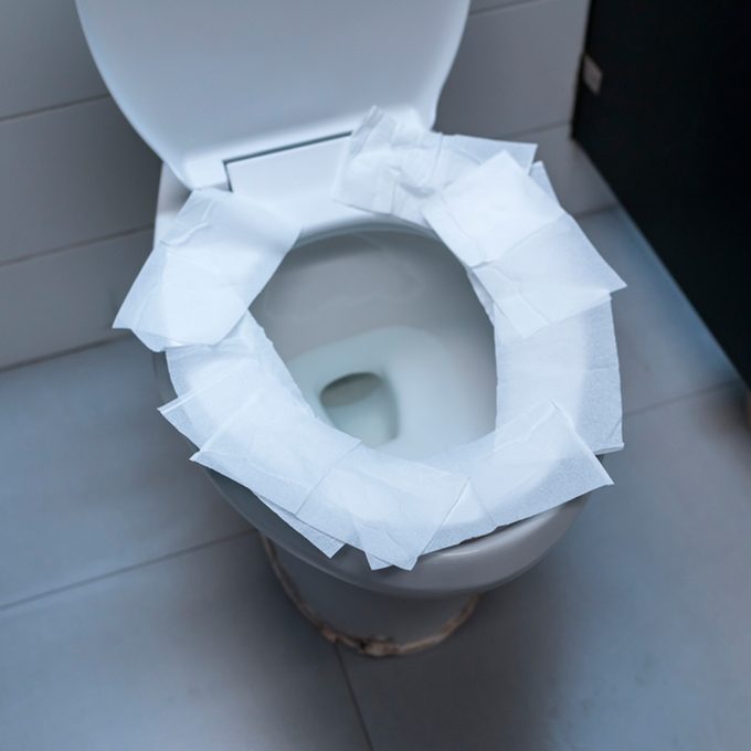 toilet paper on toilet seat