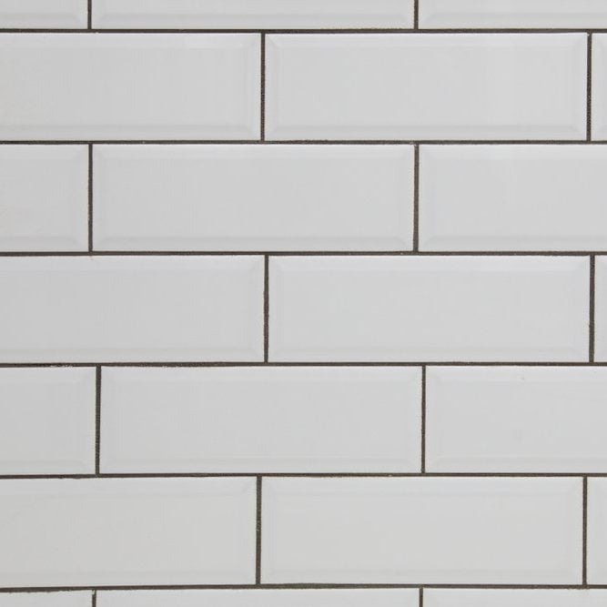 White subway tile wall and dark grout for a kitchen or bathroom backsplash
