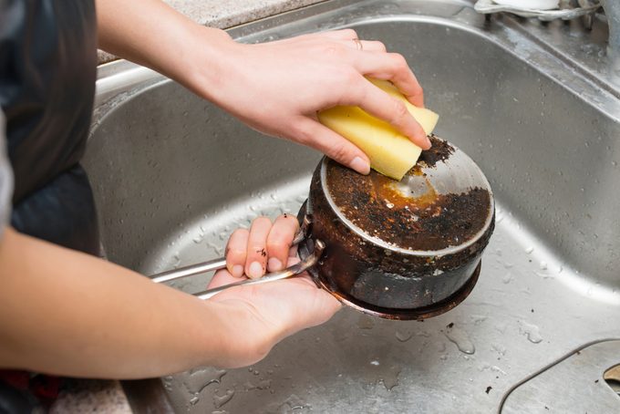 scrubbing burnt pan