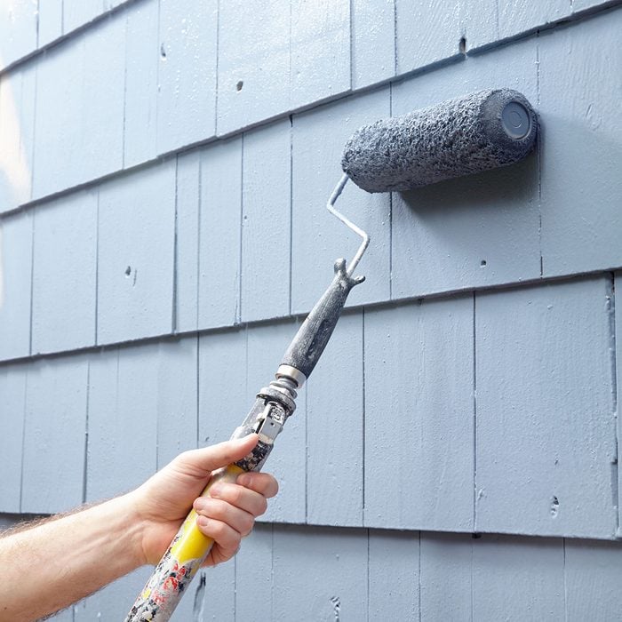 Rolling paint on to siding | Construction Pro Tips