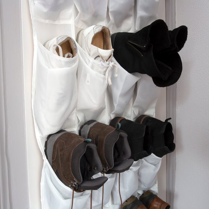 Shoe rack hanging on a wooden door, storage for shoes