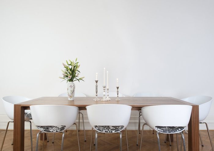 Modern dining room with big white wall