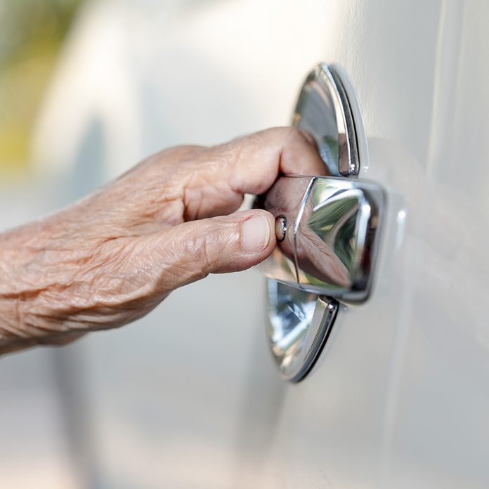 elderly woman hand opening car door