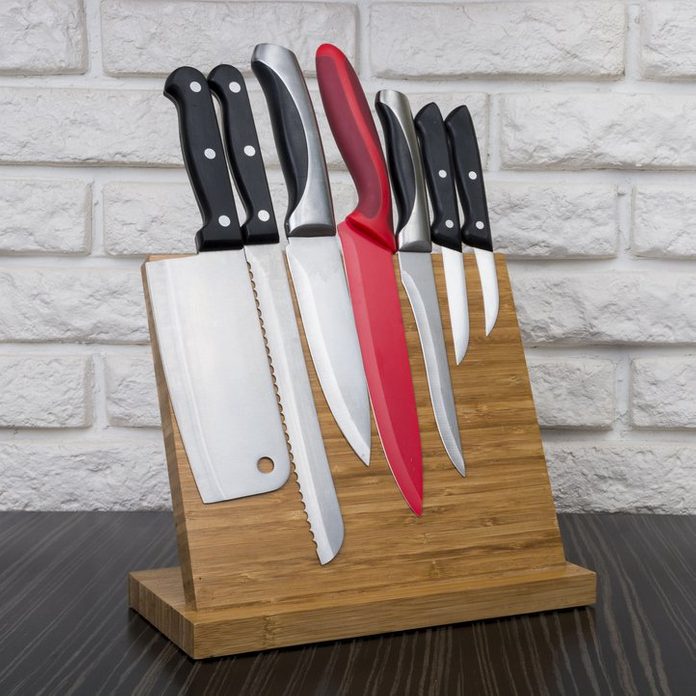 Set of knives on wooden magnetic holder ; Shutterstock ID 433957846; Job (TFH, TOH, RD, BNB, CWM, CM): TOH Knife Holder Roundup