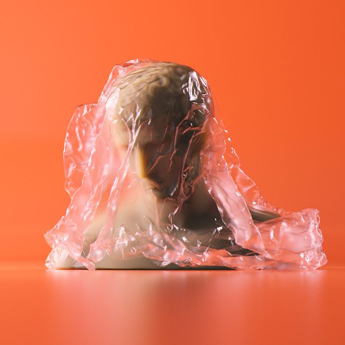 3d rendering of bust statue with cellophane wrap on orange background. Subsurface scattering marble material