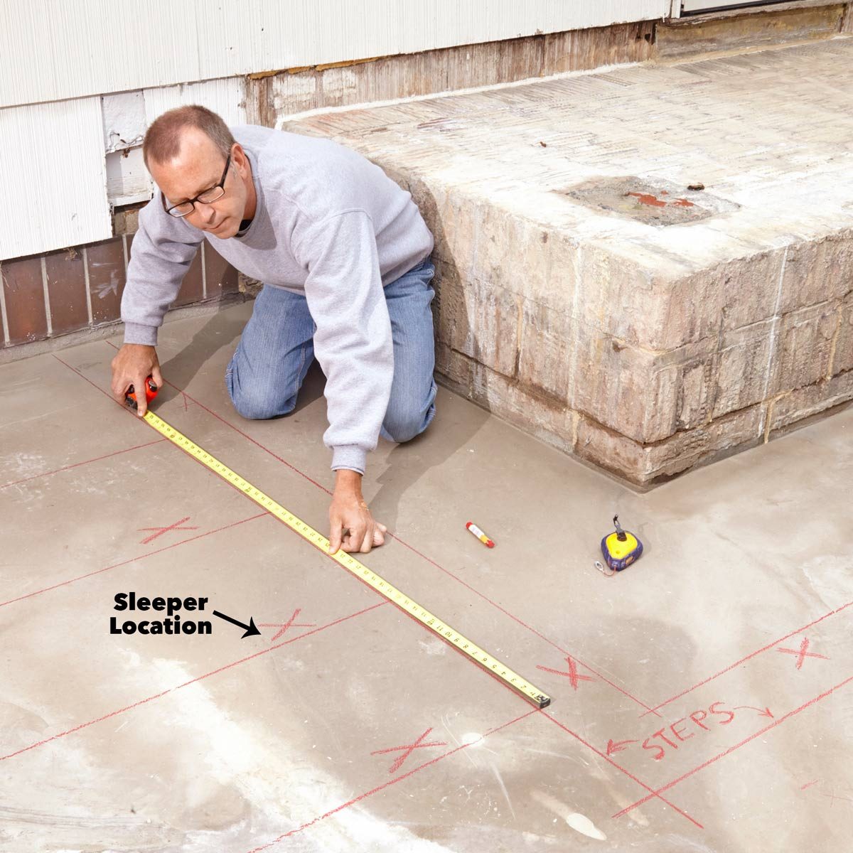 Man Measuring the floor with measuring tape