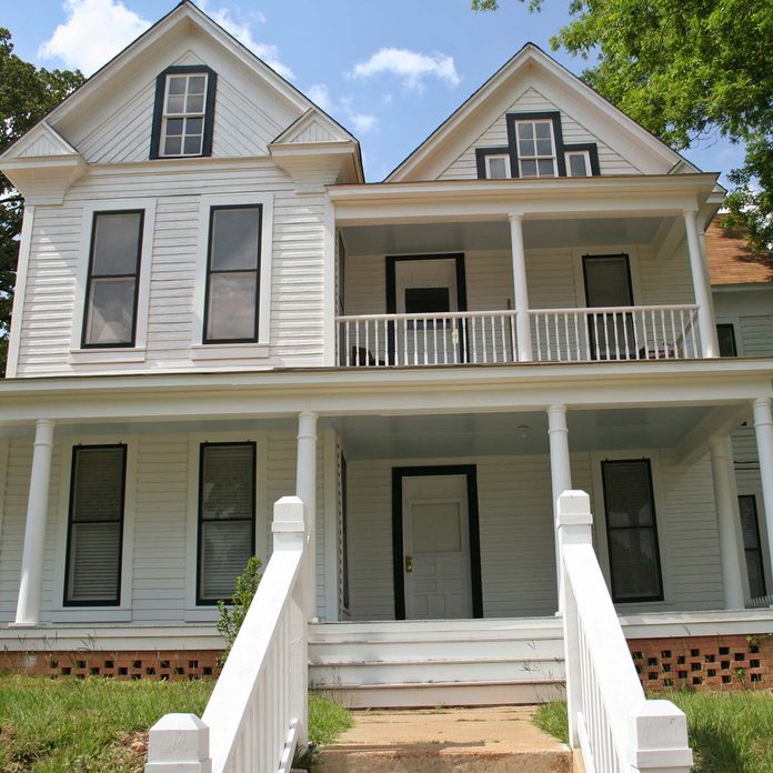 white colored historic farmhouse style home