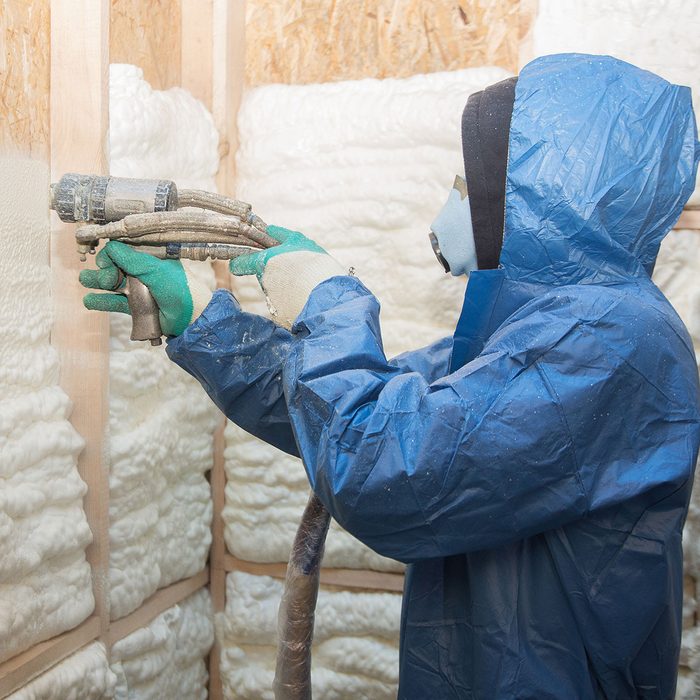 Man applies spray foam insulation