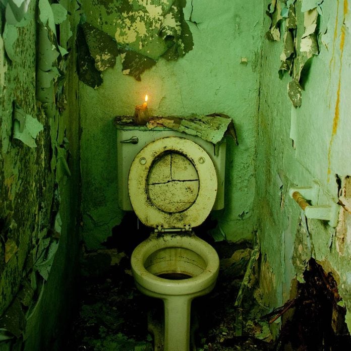 Abandoned-bathroom-with-a-candle-lit