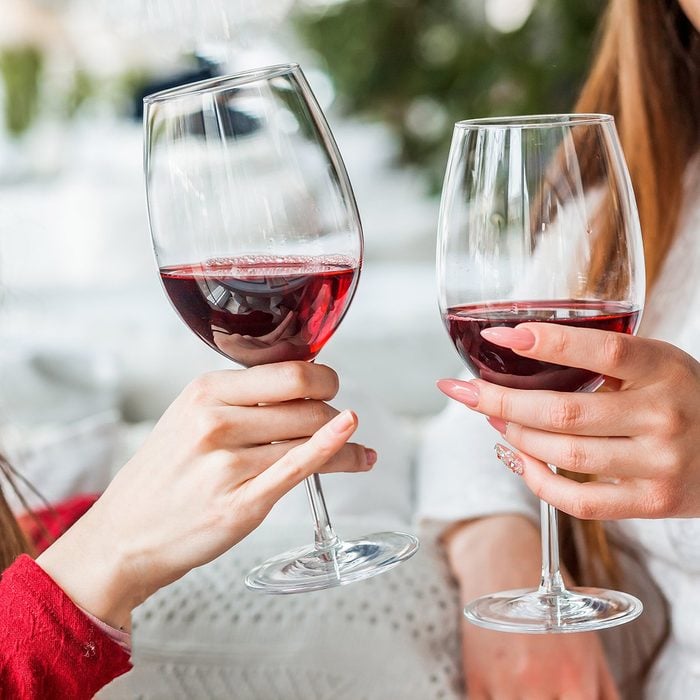 Two female friends drinking wine in restauran