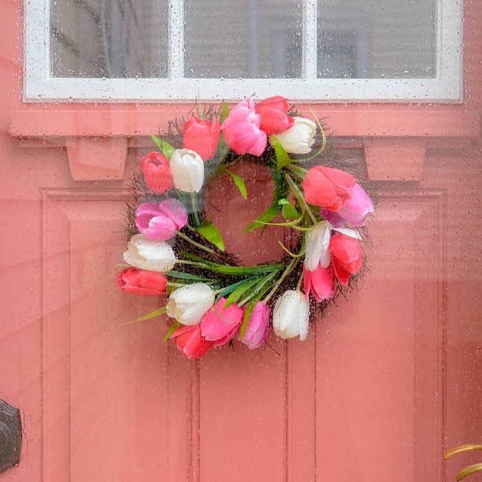 pink front door with tulip wreath