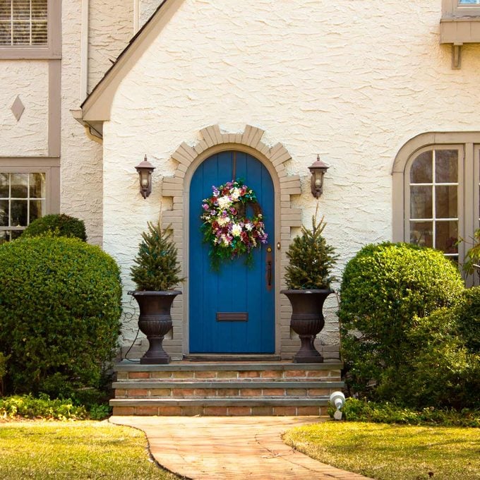 blue front door on stucco home