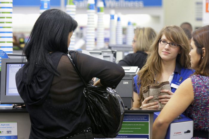 Cashier Jillian Capko, second from right, helps customers at a Sam's Club store in Rogers, Ark
