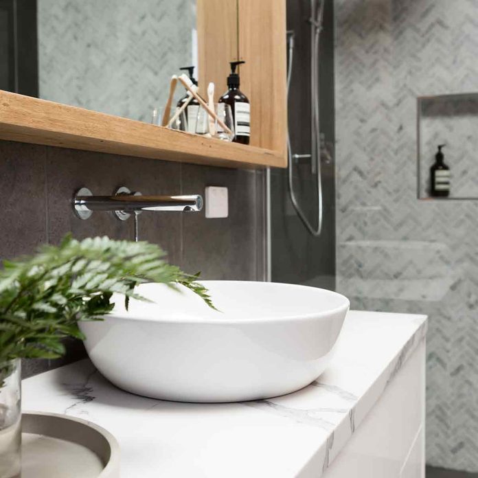 Charcoal-Bathroom-details-clean-white-basin-with-shower-tiling-behind