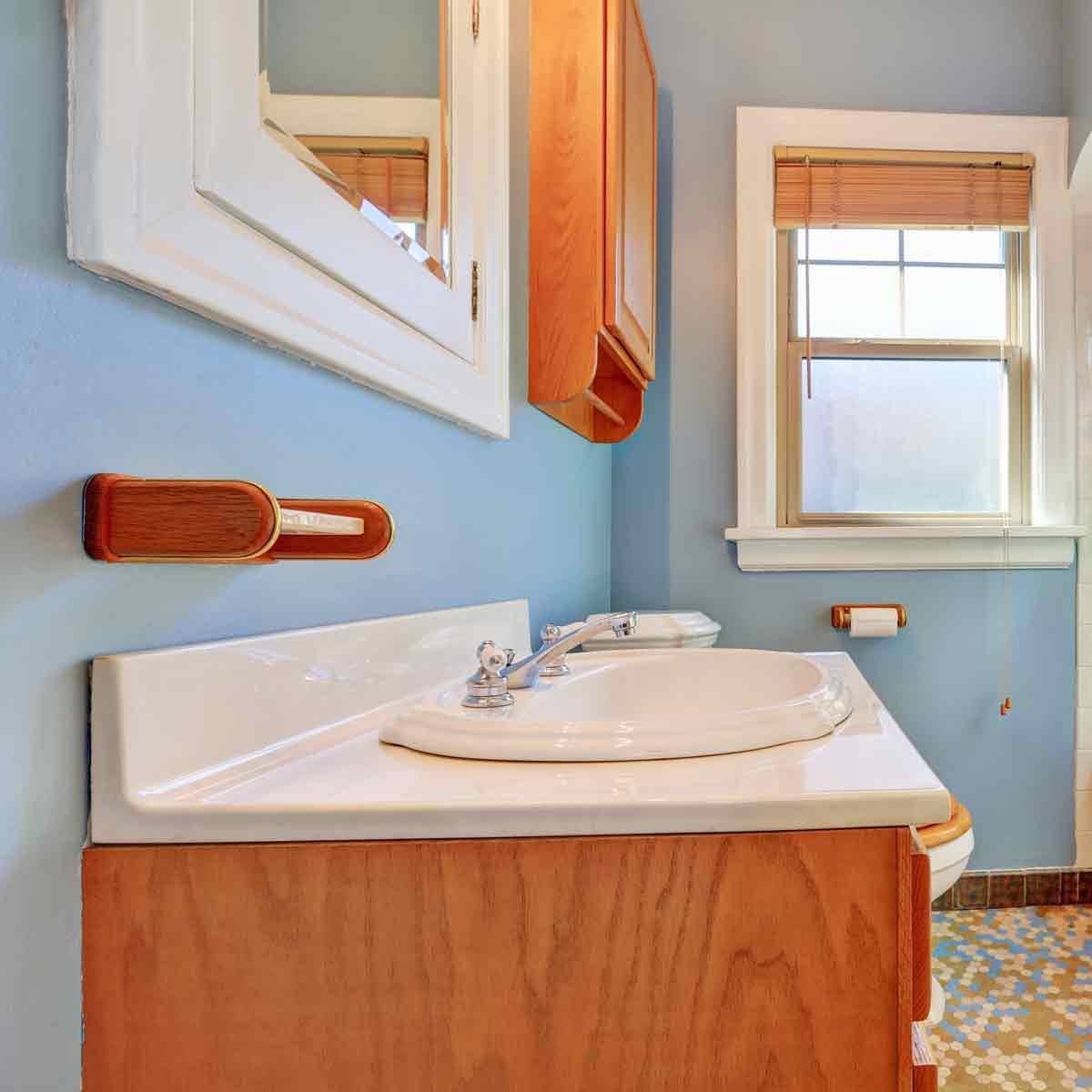 Pale-blue-colorful-bathroom-interior-with-old-fashioned-ceramic-appliances-in-tudor-style-home