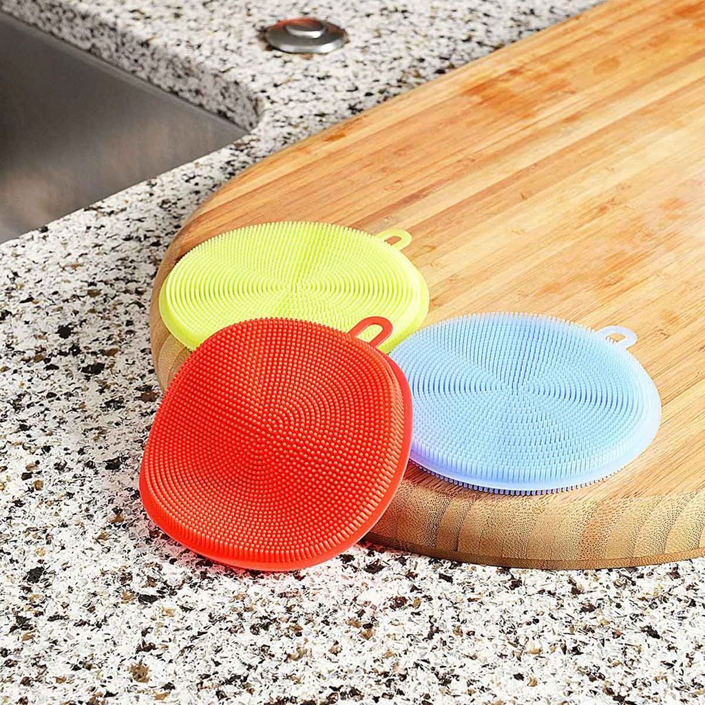 collection of silicone sponges on a wooden cutting board