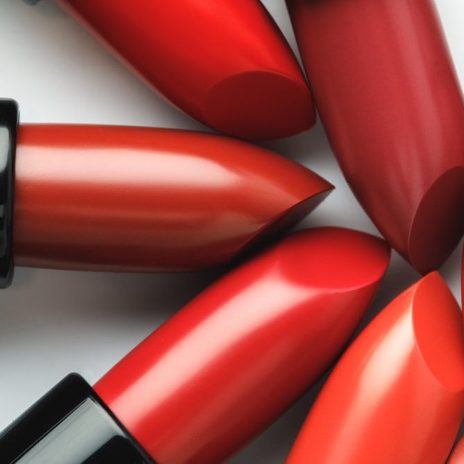 close-up shot of red lipsticks of different shades on white tabletop