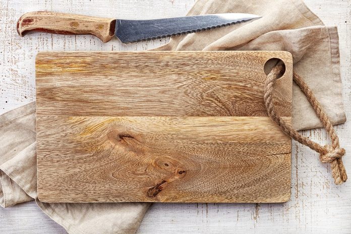 top view of wooden cutting board on old wooden table