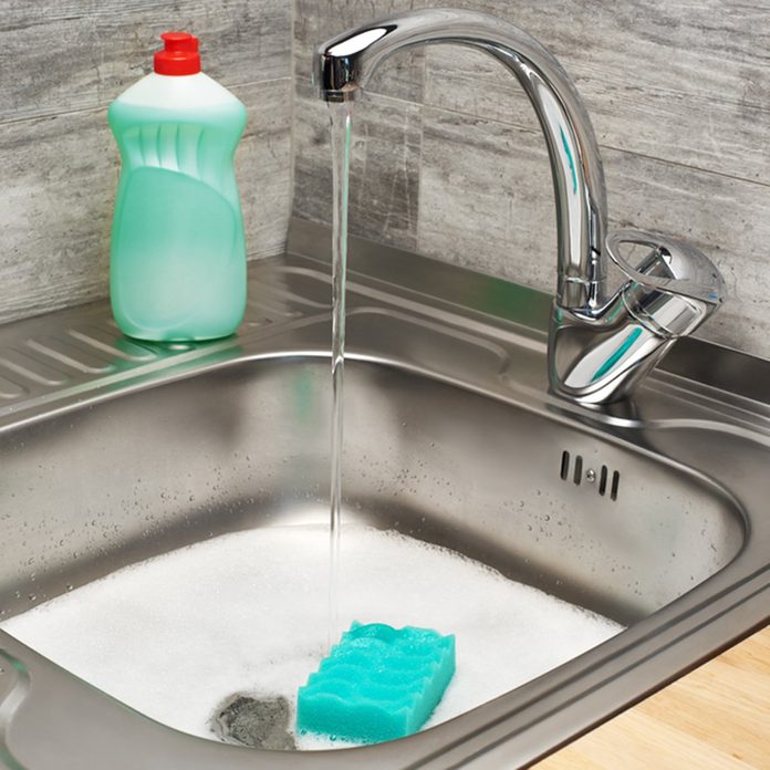 Close up of kitchen sink full of foam with running tap water, green cleaning sponge and bottle of liquid detergent; Shutterstock ID 640551559; Job (TFH, TOH, RD, BNB, CWM, CM): TOH