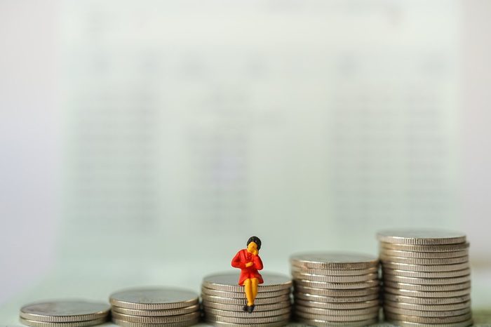 Miniature people : Business women sitting and thinking about business on stack of coins, e-commerce, online technology business concept