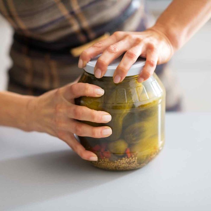 Woman-tries-to-open-a-pickle-jar