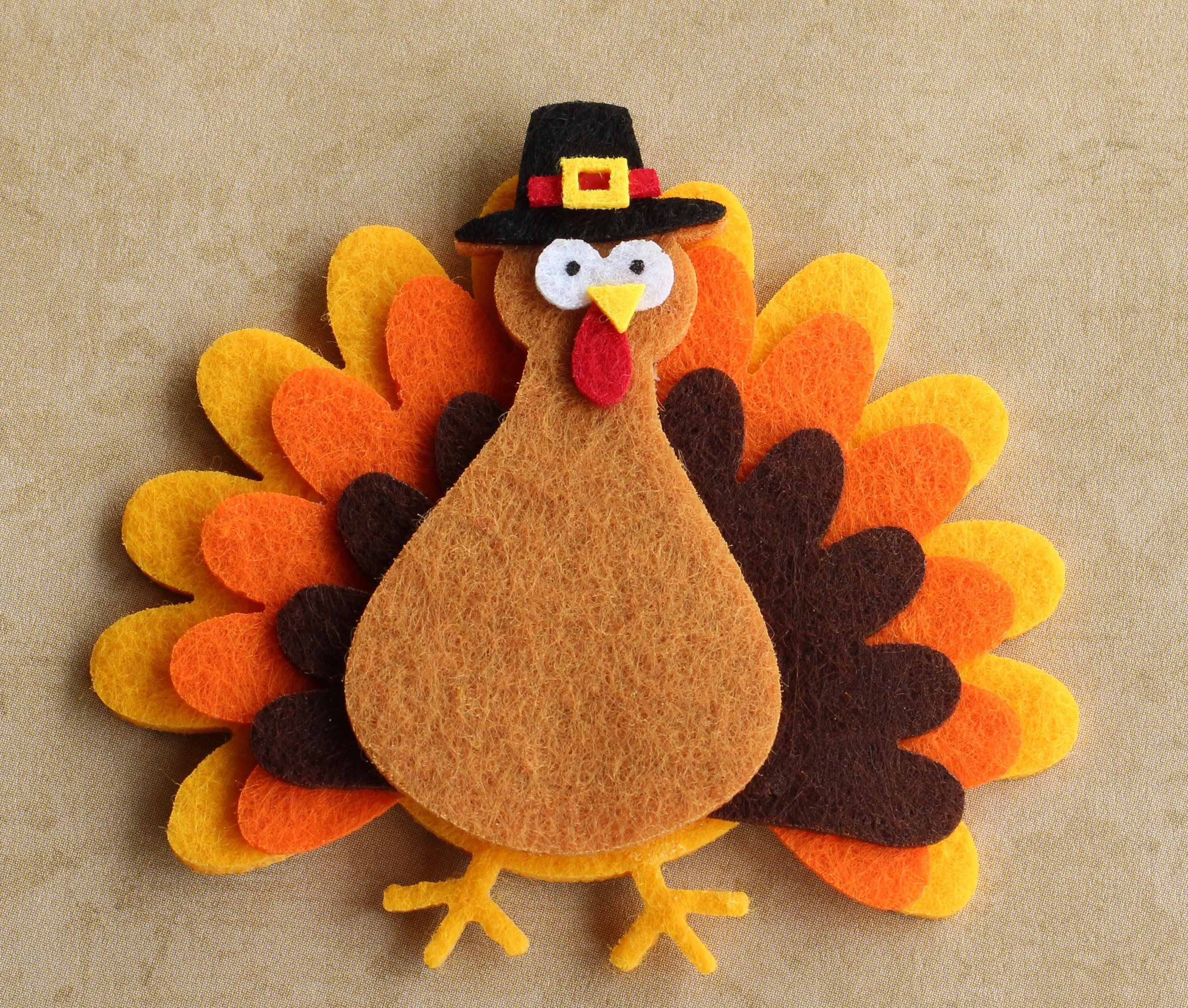 Felt turkey laying flat on a tan background with copy space