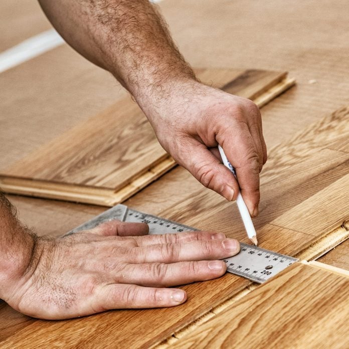 Craftsman installing engineered click system oak wood flooring