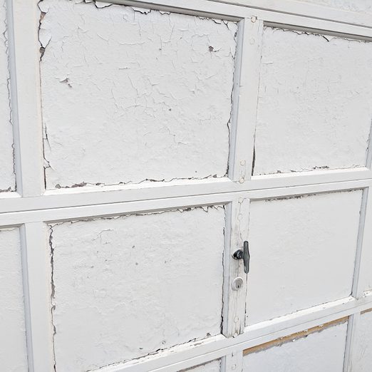 White Garage Door Panels with Old, Flaking Paint; Garage Doors that Need to Be Replaced
