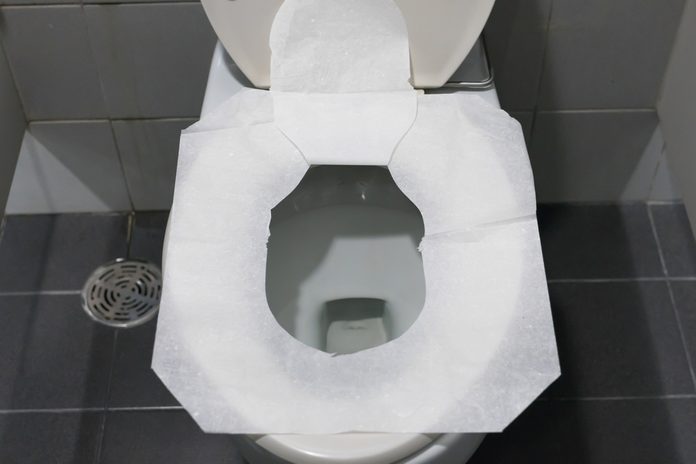 Toilet paper put on Open Toilet seat. Cover The Toilet Seat With Tissue Paper.