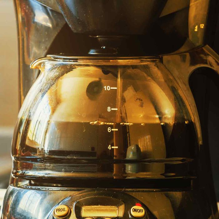 Close-up-of-electric-glass-coffee-pot-with-measurer