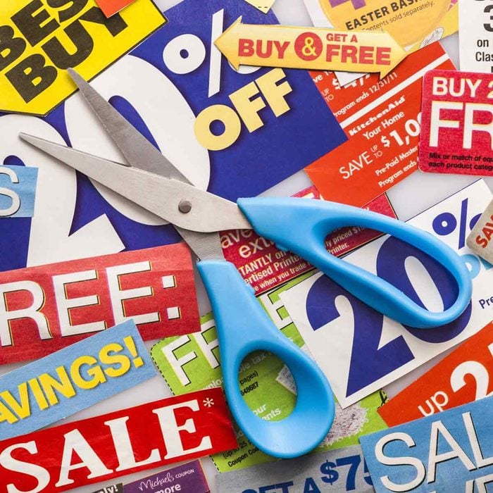 Light-blue-handled-scissors-on-top-of-coupons
