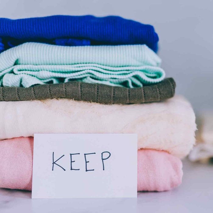 piles-of-tshirts-and-clothes-being-sorted-into-Keep-Discard-and-Donate-categories