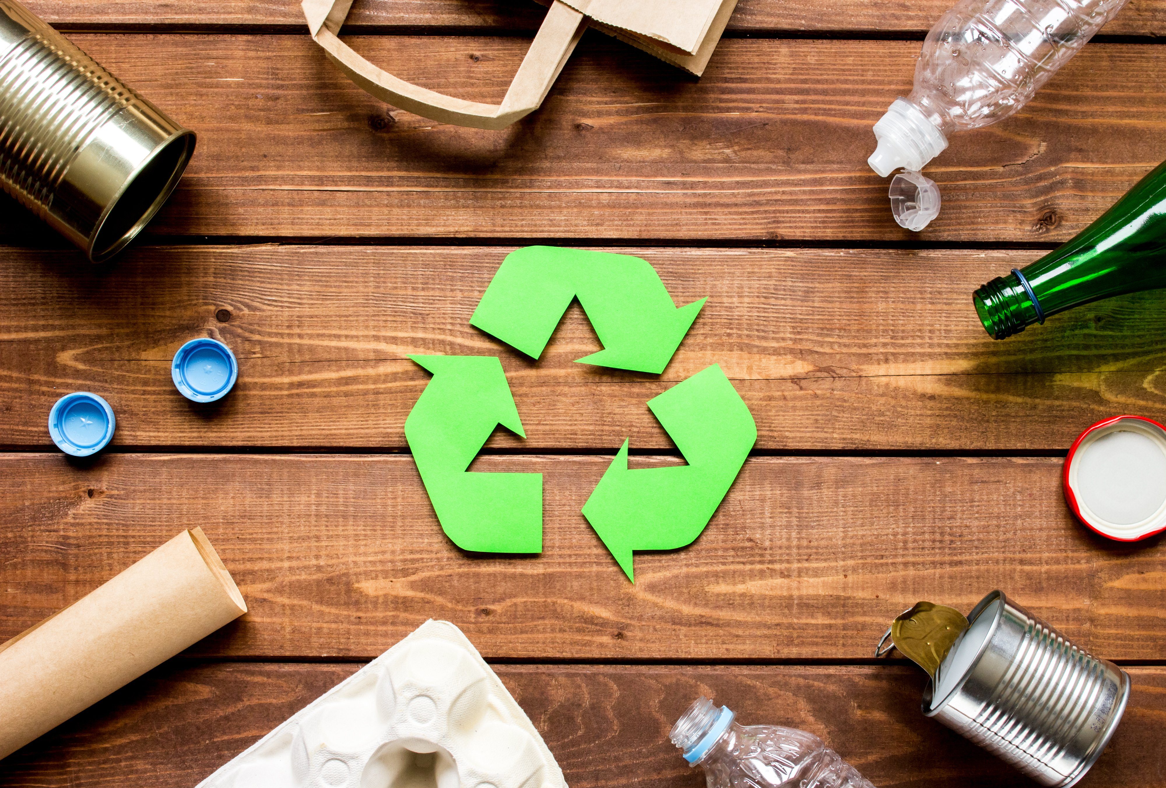 Eco concept with recycling symbol on table background top view