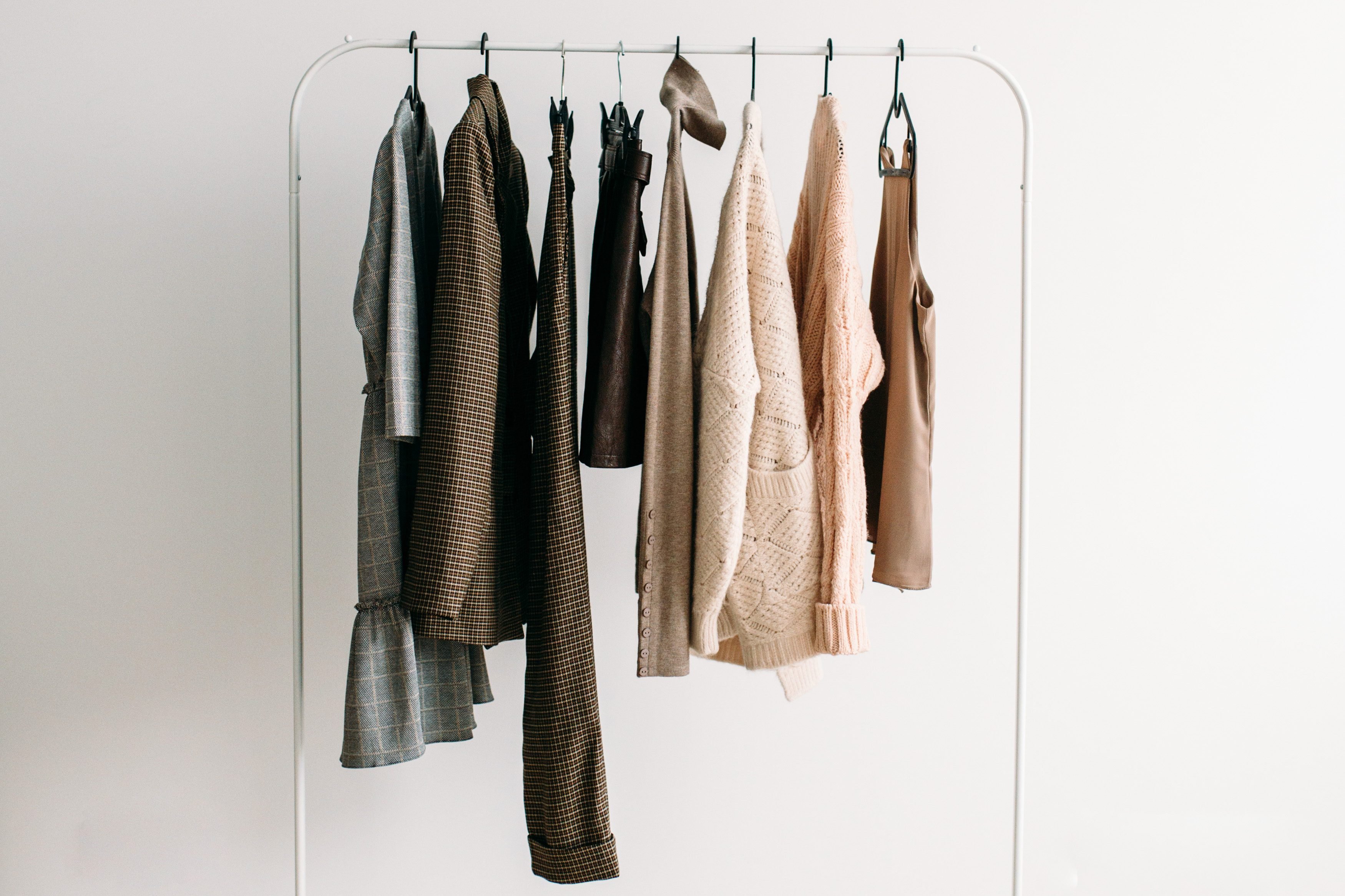 Rack with capsule clothes in beige colors