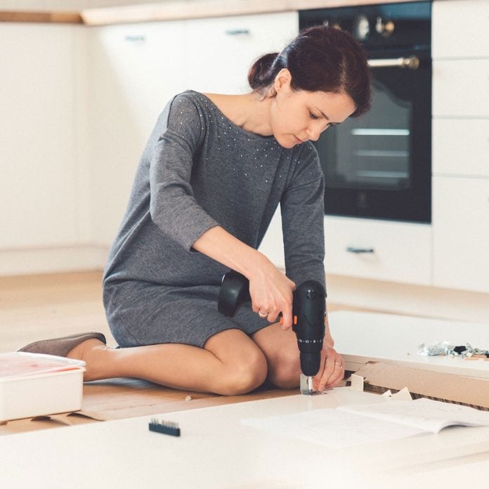 Woman building something in a kitchen