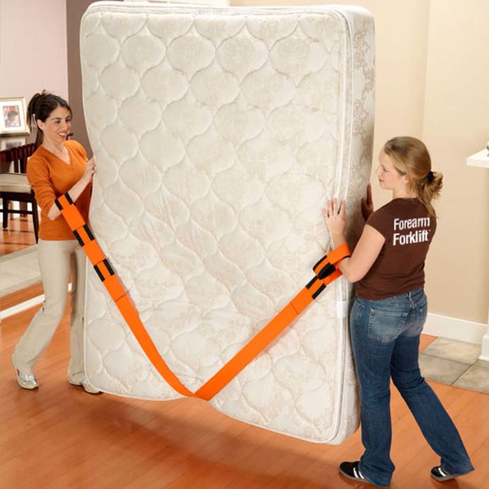 Two women using the simple model of Forearm Forklift moving straps