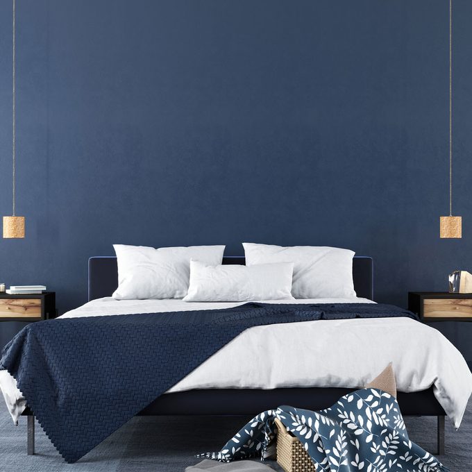 Bedroom with navy blue walls and accents