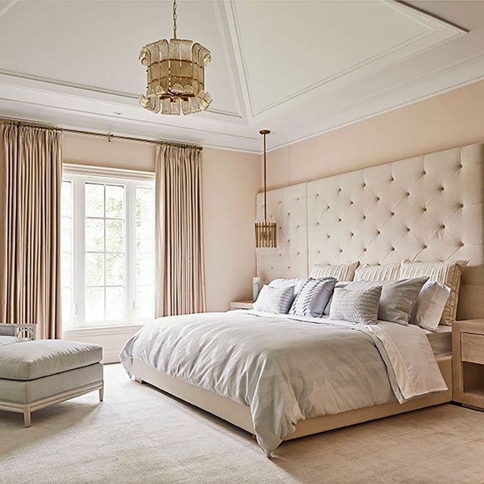 Bedroom with blush walls and cream furnishings