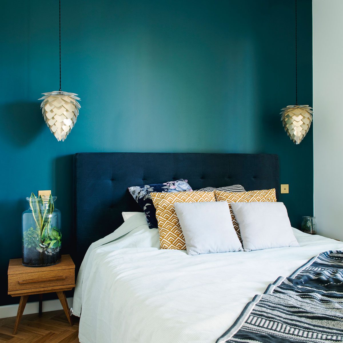 Bedroom with a deep teal accent wall