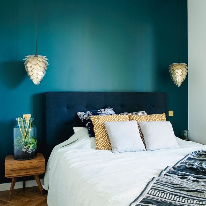 Bedroom with a deep teal accent wall