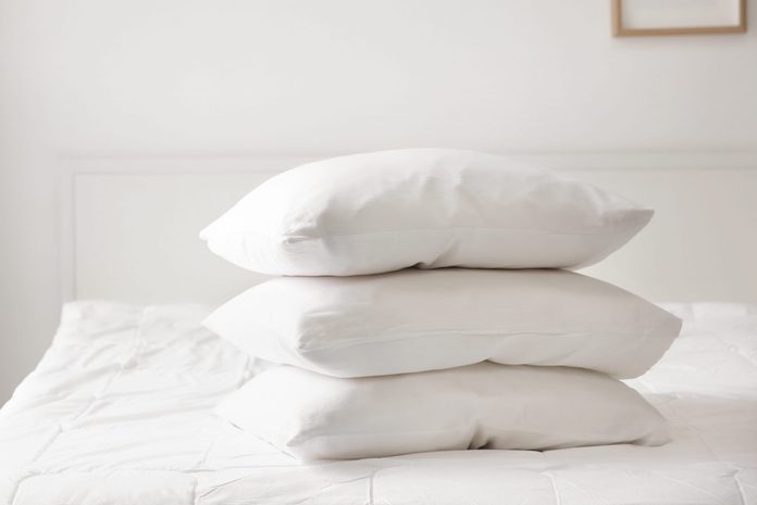 Stack of pillows on bed