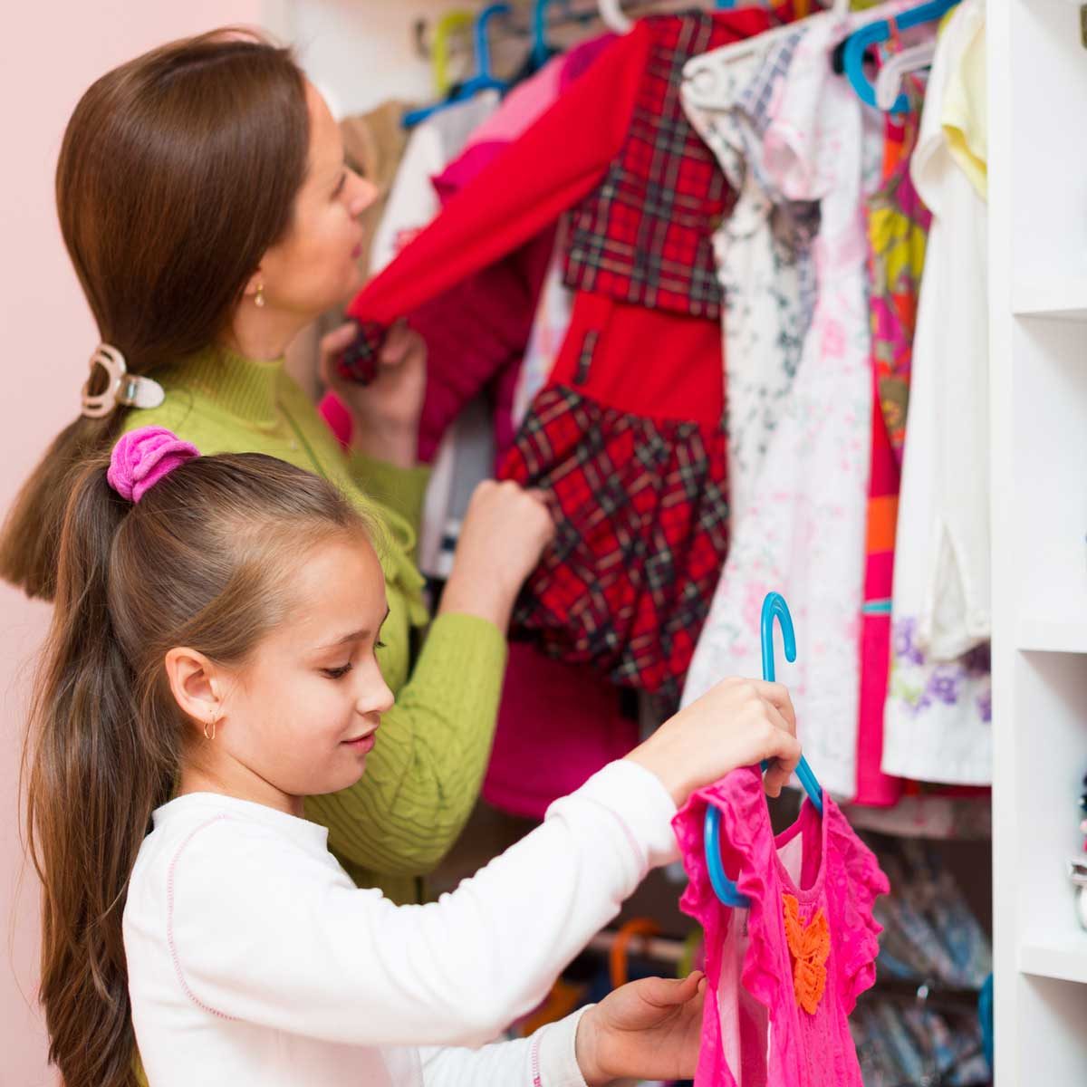 Mon and daughter organizing a closet