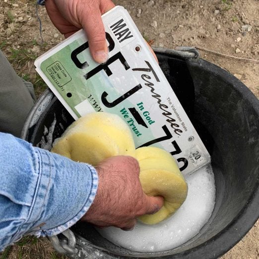 Cleaning a license plate