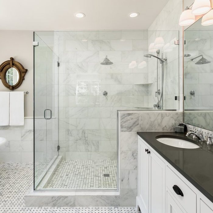 Master bathroom in new luxury home: Bathtub and shower with tile and glass shower doors