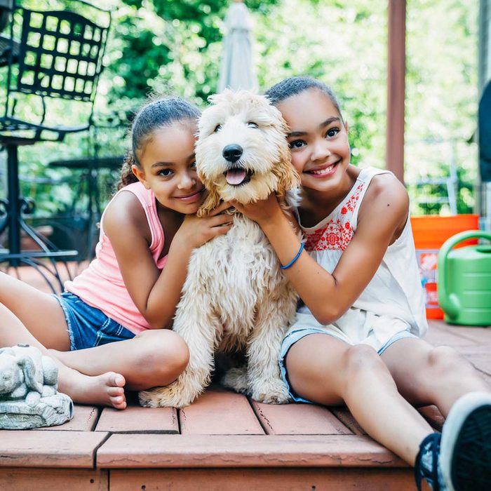 Young sisters with their dog